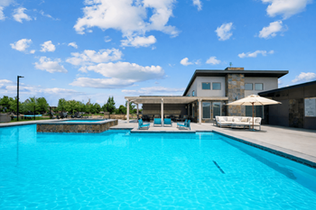 Large swimming pool with modern clubhouse and patio
